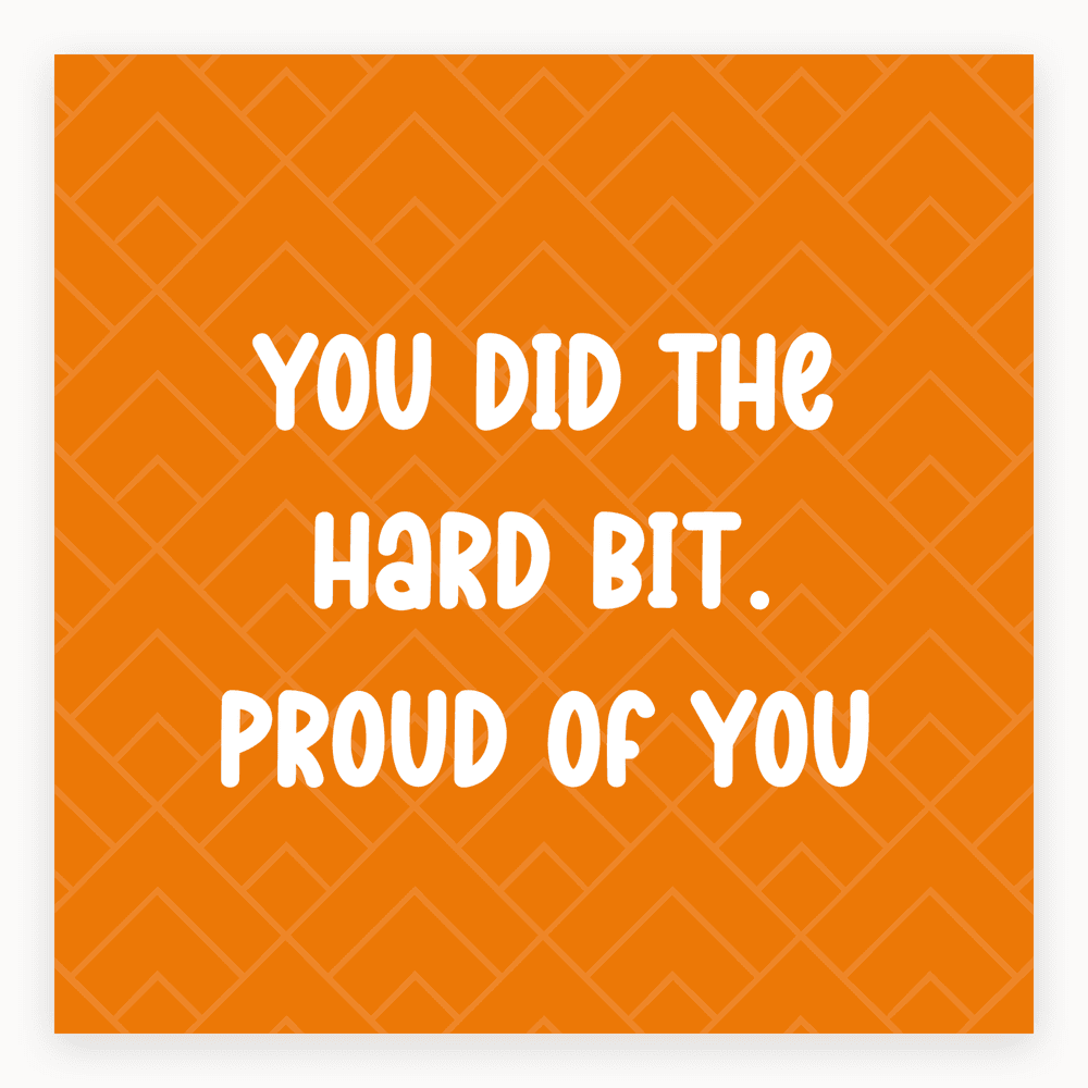 The card lying flat. Orange card with white text saying 'You did the hard bit. Proud of you'. Modern design.
