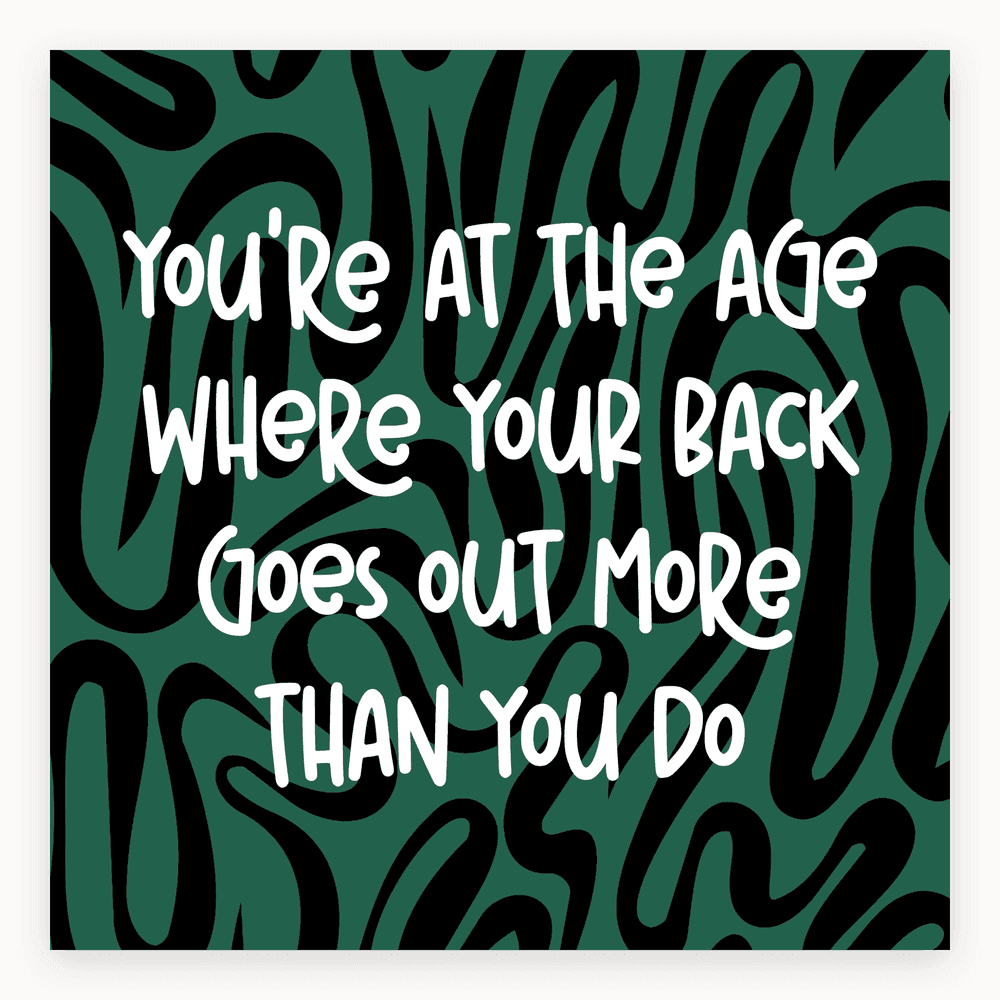 The card lying flat. Card with humorous text about ageing on a green and black abstract background.